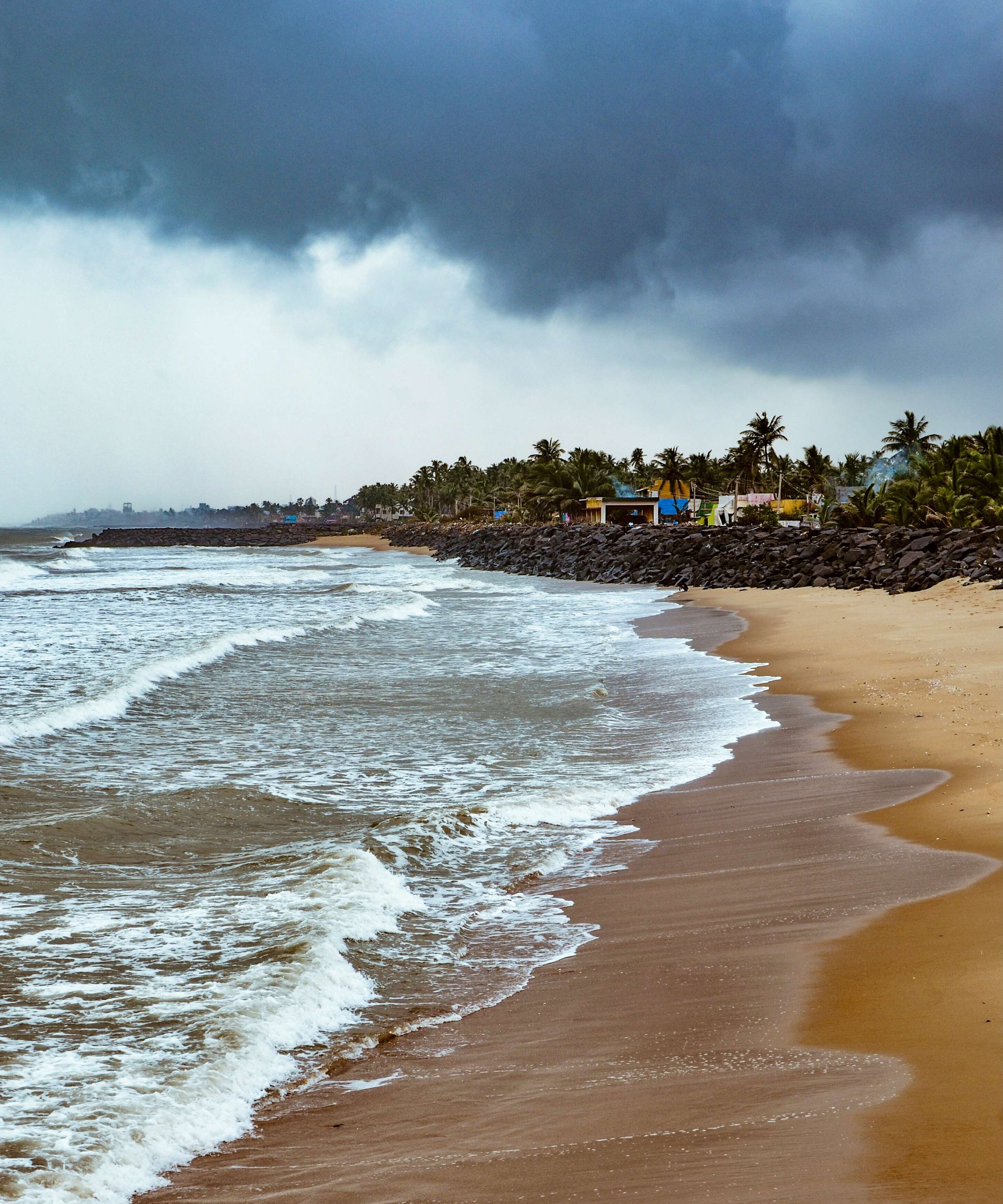 beach shore under cloudy sky during daytime